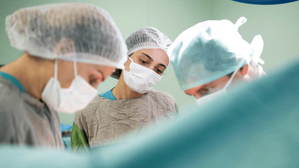 Multidisciplinary surgical team performing advanced cancer surgery in a modern hospital setting