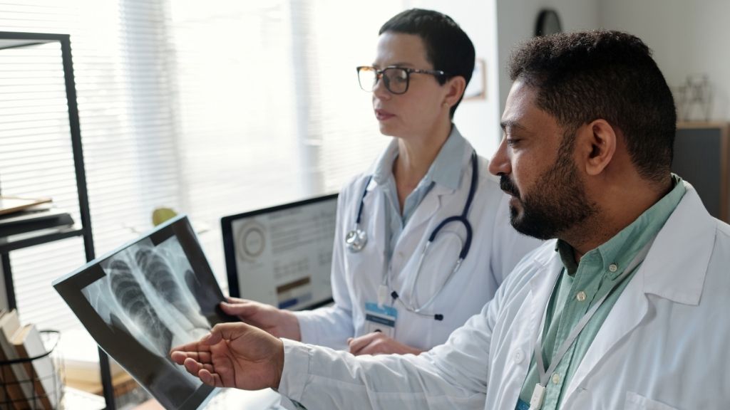 Doctors reviewing a medical image as part of CAR-T therapy evaluation in Barcelona